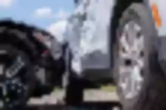 Close-up of crushed vehicle bumper after car accident, showing damage relevant to personal injury claim