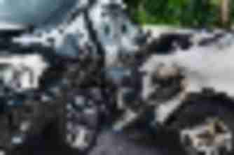 Black sedan and white car crumpled together after a T-bone collision, grounds for a car accident injury claim